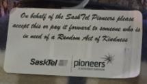 Labels read: On behalf of the SaskTel Pioneers, please accept this or pay it forward to someone who is in need of a Random Act of Kindness Assembly of RAK packages to include: Scarf or mittens, gift