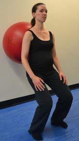 Straighten knees by sliding up to starting position while maintaining lower back flat against wall.