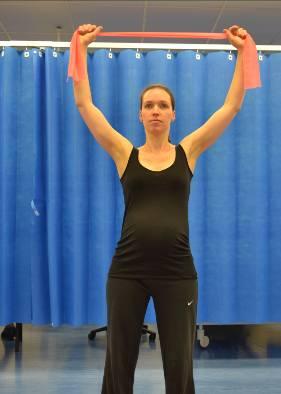 Chest stretch with band Standing feet shoulder-width apart, shoulders back,