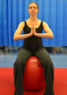 Spine twists on ball Sitting on a gym ball pelvis and lower back in neutral. Hands in prayer position with hands rested at sternum, shoulders relaxed neck long. Rotate trunk.