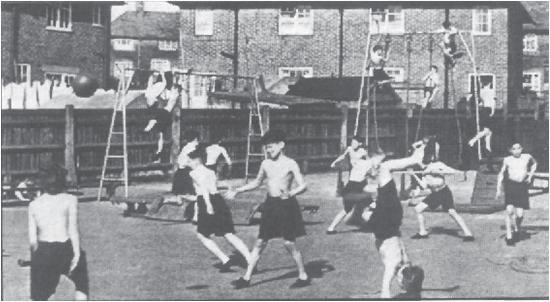 12 5 (b) Figure 6 shows children taking part in a physical education lesson based on the programme Moving and Growing, which was designed for primary schools in the 1950s.