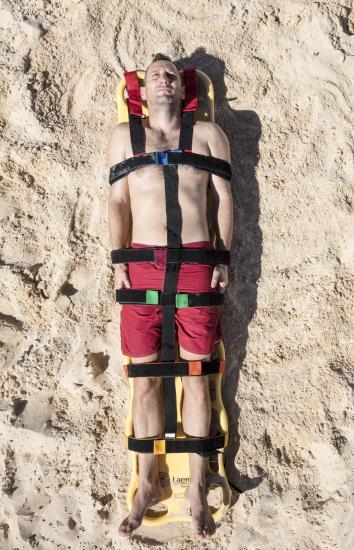 Strapping A spinal board placed under the victim can be used by first responders should it be necessary to extricate the person.