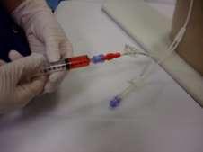 Open syringe and needle packaging and draw up saline 20ml 6.