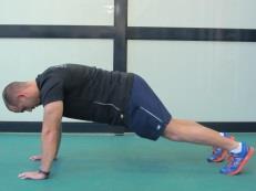 under the bar and position feet parallel to each other. Hold the chest up and out.