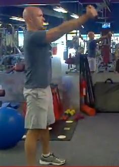 Hold a single Kettlebell or dumbbell in both hands in front of your body at arm s length.