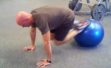 Tuck your knees to your chest by rolling the ball to your chest by contracting your abs and pulling it forward. Return to the starting position.