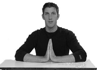 Assisted Flexion With Arms on Table: Sit with arms on table and hands in a prayer pose. Keep palms together and elbows on table while sliding elbows together.