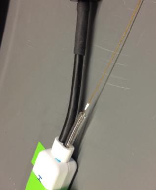 Extend the cryogen delivery tube: First, trim some of the clear vacuum line that attaches to the catheter handle in order to expose some of the cryogen delivery tube (this is the orange, polyimide