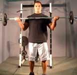 Curl bar up in a semicircular motion until forearms touch your biceps.