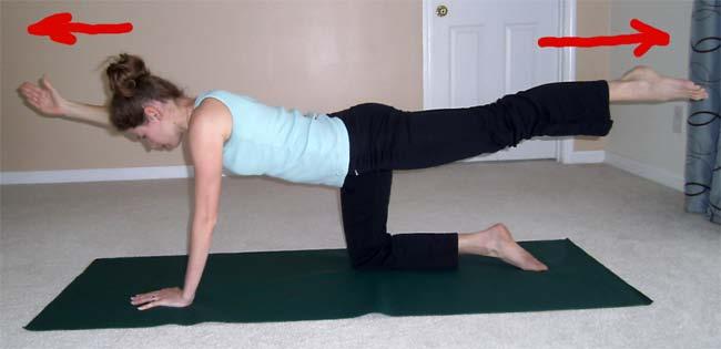 Phase 2: Inhale as you slide your opposite arm and leg out and lift them up in the air parallel to the floor.