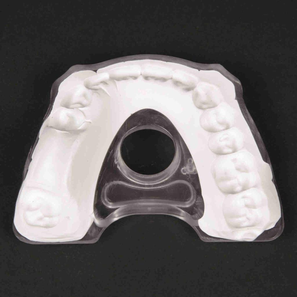 Apply bite registration material over the whole inner surface area of the bite plate (side without the fiducial
