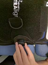 The second person can now position the back panel of the brace.