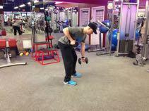DB Piston Row Stand with knees bent, back flat, chest up, and hold a dumbbell in each hand.