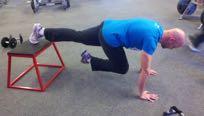 Keeping your abs braced and your body straight, bring in one knee towards the opposite elbow.