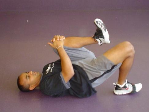 the opposite knee is held into the chest to limit
