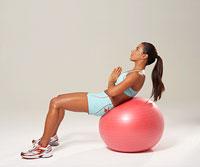 Ball Crunch Targets abs, hips, thighs Sit on the ball and walk your feet out and forward of your knees, sliding your butt down so your body is at a slight incline.