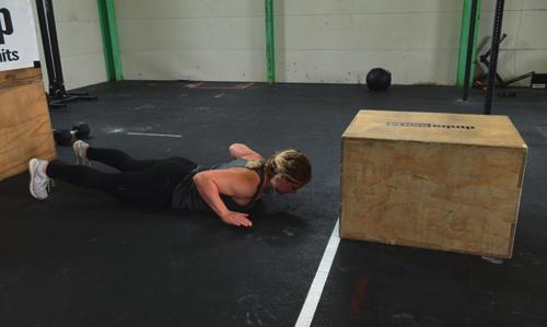 Hand release Burpee Box Jumps: At the bottom the athlete s hip and chest