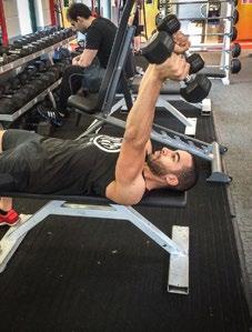Bend your arms at the elbow, lowering the dumbbells until they are behind your head, then extend your arms back to the