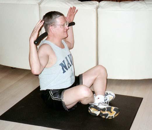 Stretch by Spinal Rotation Begin in a seated position, with legs crossed. Sit up straight, chest lifted, with the Body Bar FLEX behind the neck.
