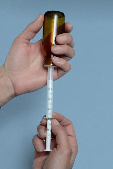 Secure dose of medicine by printing the medicine s name on the dosing syringe and/ or by using the same color of the plunger as the color coding of the