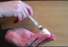 2) Flip off the top of the hydrocortisone vial. Tap the top of water ampoule to remove liquid from the top.