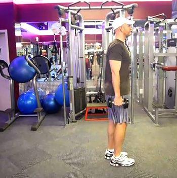DB Walking Lunge Stand with your feet shoulder-width apart, holding a pair of dumbbells at your