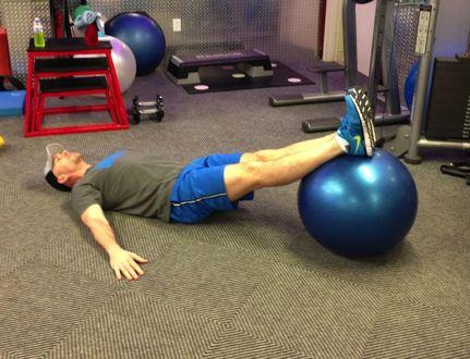 Workout A Stability Ball Leg Curl Lie on your back with the soles of your feet on a