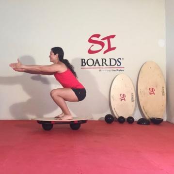body Crab position with feet on tail and hands on nose and body facing ceiling for full body Surf position dynamic jump push-up pulling board towards hips and