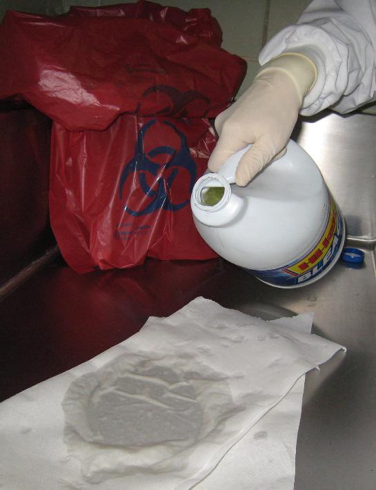 Decontamination and Cleanup Isolate the area Put on disposable gloves at the minimum Place paper towels over the material Saturate the paper towels with