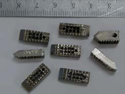 Figure 4: Picture showing the spacers of various sizes. The spacers are made of titanium and have spikes. There are multiple holes within the body of the spacers for assistance with bone healing.