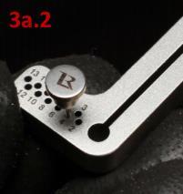 The guide is dropped over the pin using one of the numbered holes in the vertical arm, corresponding with the size of