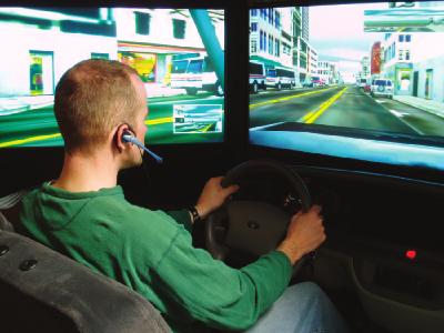 David L. Strayer and Frank A. Drews Fig. 1. A participant talking on a hands-free cell phone while driving in the simulator.