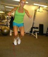 Standing to one side of the rope, begin jumping from side to side over it, maintaining your posture and