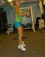 As you are jumping up, bend your elbows to curl the dumbbells up in front
