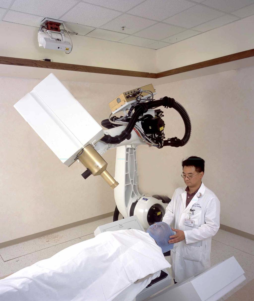 industrial robot is used to move a small linear accelerator through a preplanned path to focus an array of beams from many different directions.