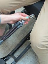 D.Tucking Leg Mechanism Back under the Wheelchair Remove user s legs from Foot Plates and place on ground Detach resistance bungee from notch at the front of the seat by unattaching the carabener and