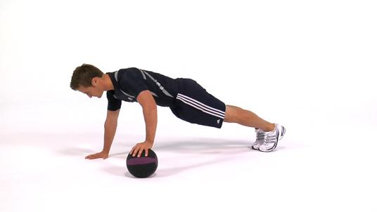 Medicine Ball Push- Ups Kneel before medicine ball. Place left hand on top of ball and right hand on floor, slightly wider than shoulder width away.