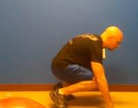 Hold a single Kettlebell or dumbbell in both hands in front of your body at arm s