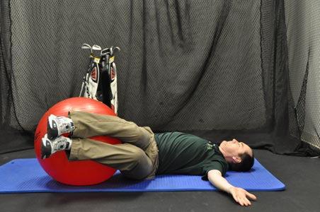 feet resting on the Swiss ball as pictured below. Now lightly grab the ball with your feet and thighs.