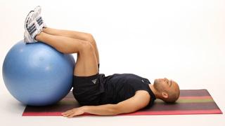Lie on your back, heels on the Stability Ball, arms out to the side on the ground.