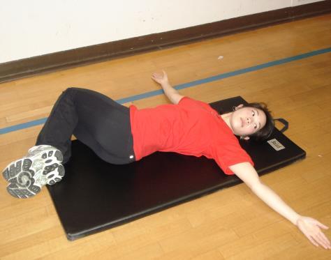Supine Trunk Rotation Area stretched: Trunk Lie flat on back with both knees bent towards one