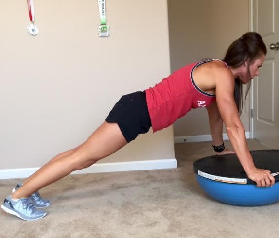 BOSU Wide to Narrow Jumps in Pushup BW. Begin in push up position with hands on the platform side of the bosu ball.