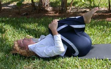 Double Knee to chest Lie on your back on your mat with your arms to the sides, your knees bent, and your feet flat on the floor.