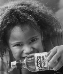CDC Fluoride Recommendations Consumer Product Industry & Health Agencies label bottled water promote use of small amounts of toothpaste with children develop a low-fluoride toothpaste for children ~