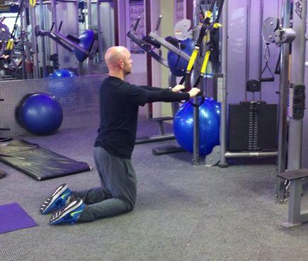 TRX Ab Fallout Kneel on the ground with your hands in the straps.  tensed.