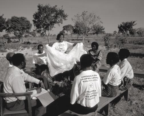 UNICEF/HQ98-0922/PIROZZI In Zambia, a community malaria committee discusses the value of inexpensive, locally available mosquito nets treated with insecticide.