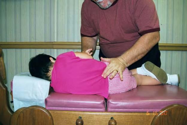 Lumbar and Sacral Segments Prone Place the child on the table or across your lap. Contact the spinous process with a pisiform, thumb - pisiform, double thumb, or double index finger contact.