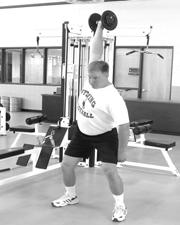 Extend the knees and hips while shrugging the shoulders to pull the weight to the shoulder.