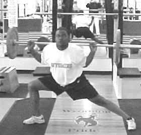 Overhead Squats Start with feet parallel and slightly wider than hip width apart.