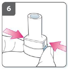 6. Pierce the capsule: Hold the inhalation device upright with the mouthpiece pointing up. Press both buttons fully one time. You should hear a click as the capsule is being pierced.
